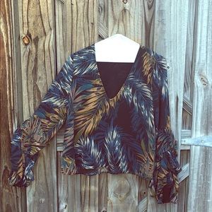 Gorgeous v-neck flowy blouse with ruffle sleeves.